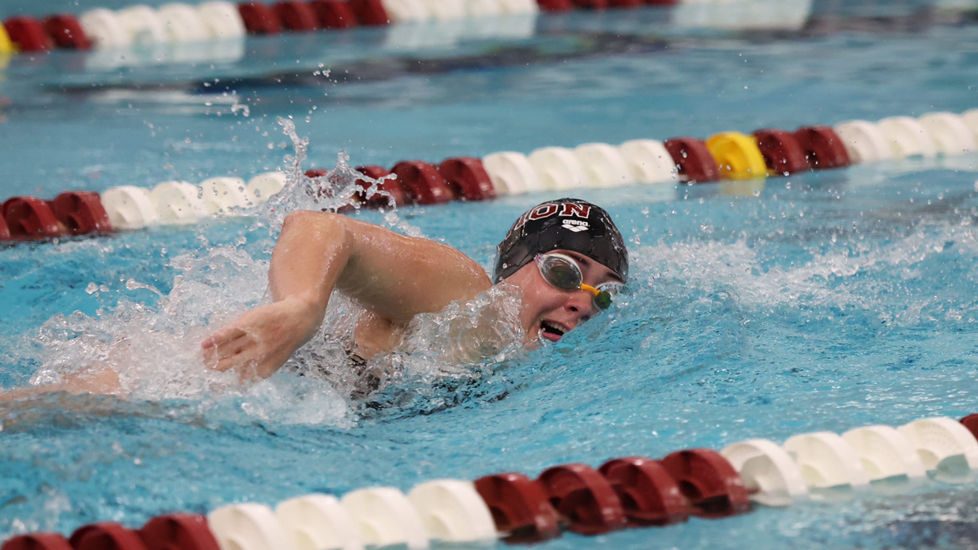 a women's swimming student-athlete swimming the front crawl