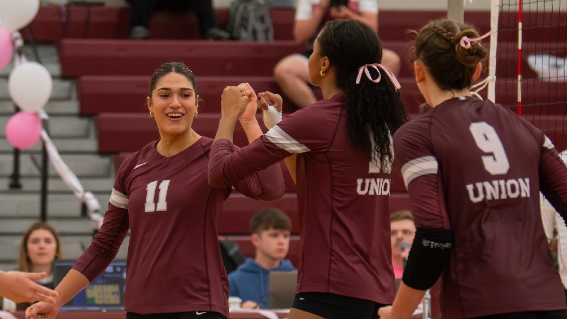 women's volleyball players celebrating a point