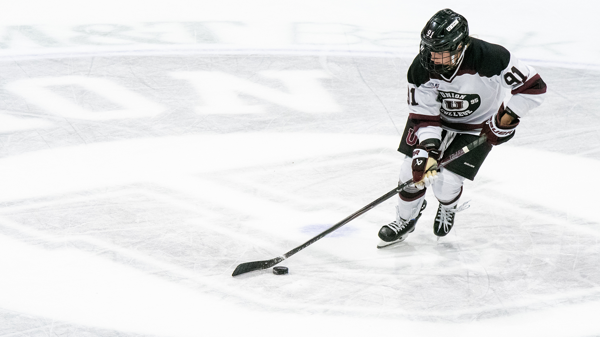 Women's Ice Hockey Player Jill Willis Attacking Puck 