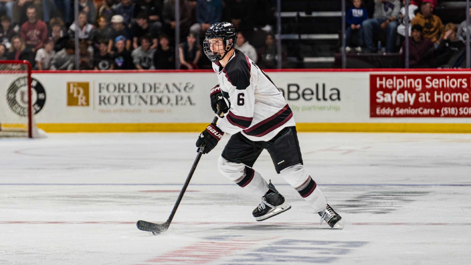a men's hockey player skating in open ice