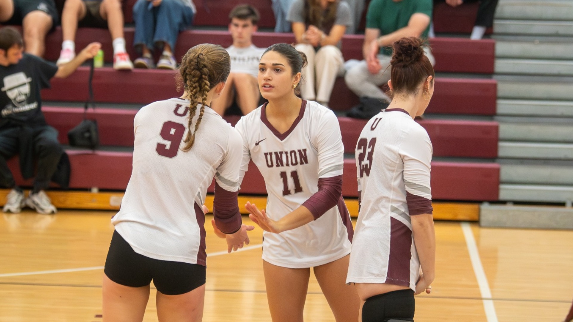 women's volleyball players talking between a point