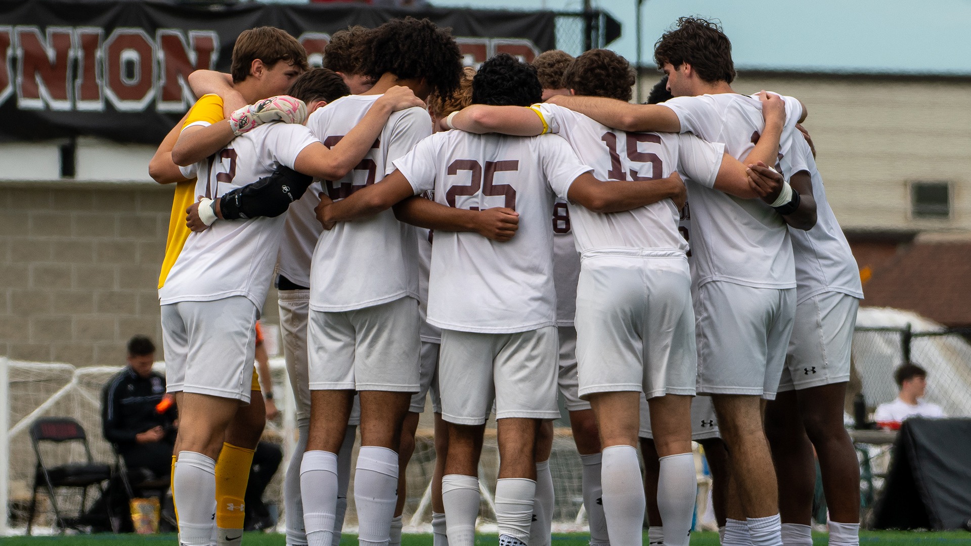 A huddle of men's soccer players.