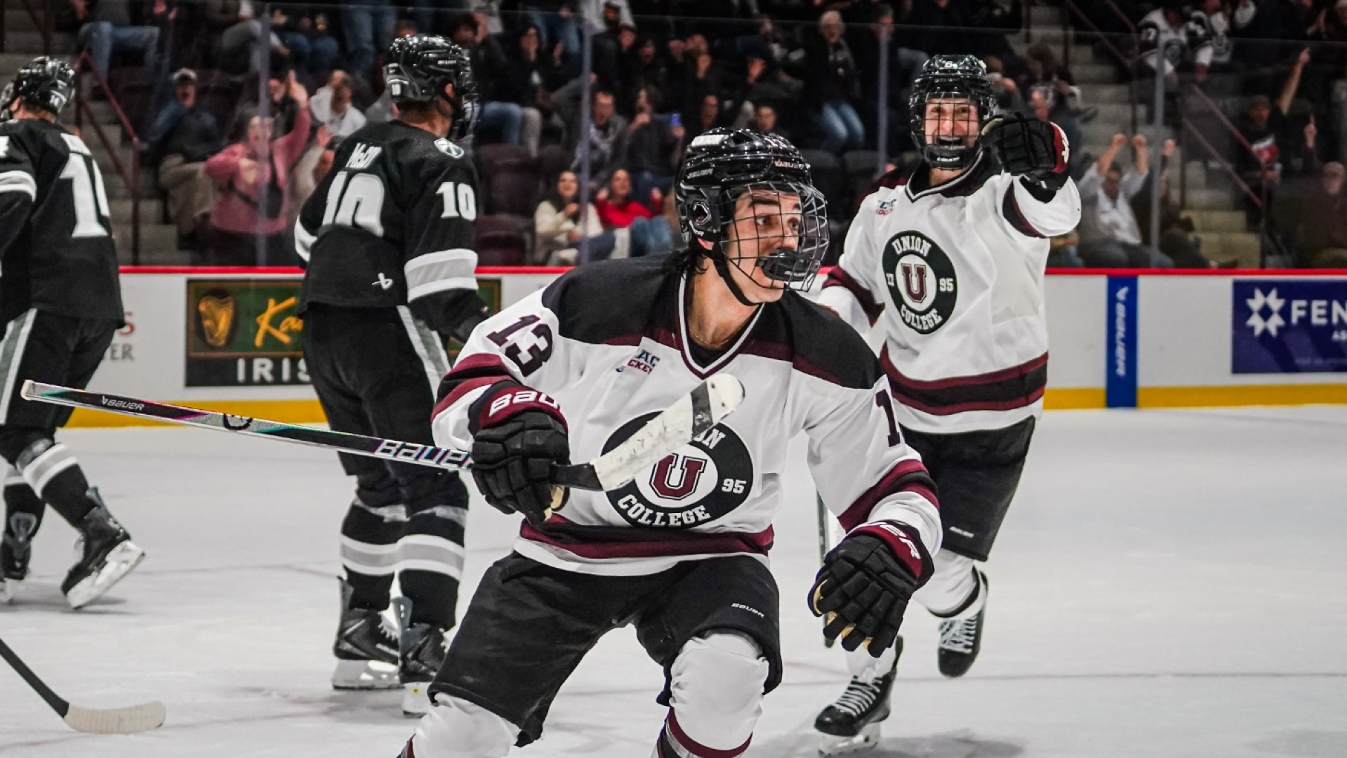 a men's hockey player celebrating a goal