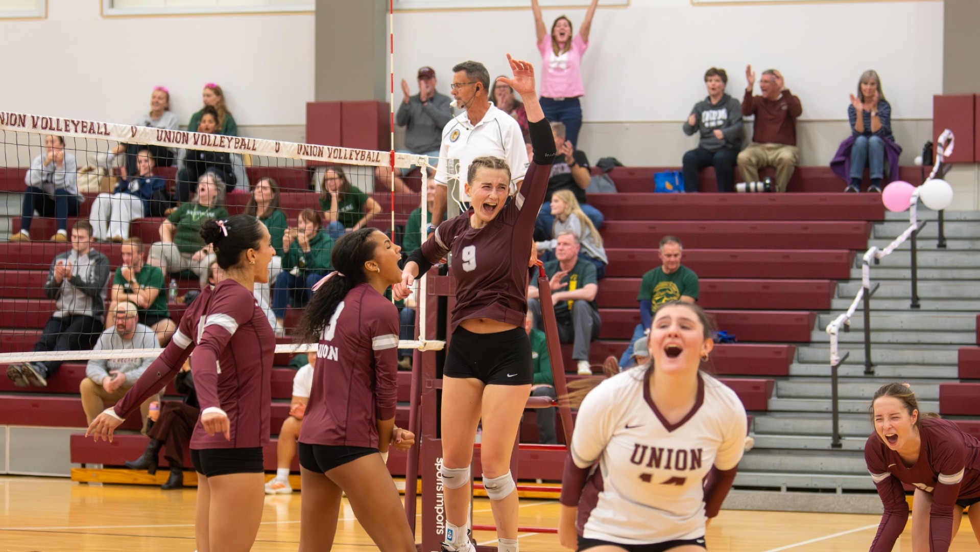 volleyball players celebrating after a point