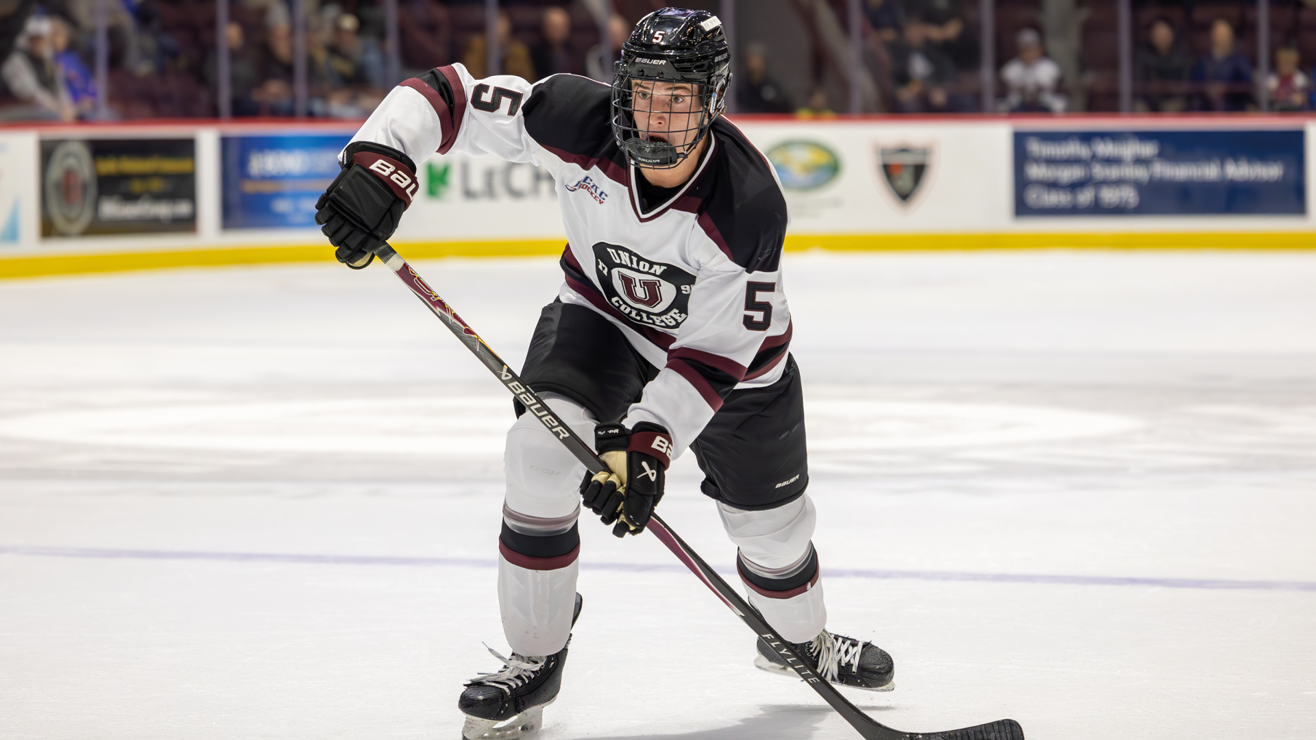 a men's hockey player making a pass