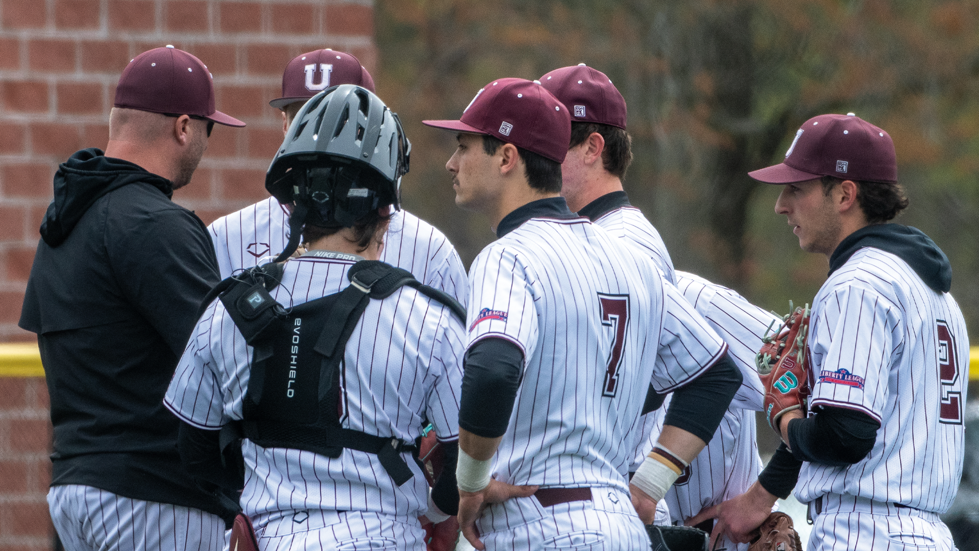 a baseball team talking on the mound with each other