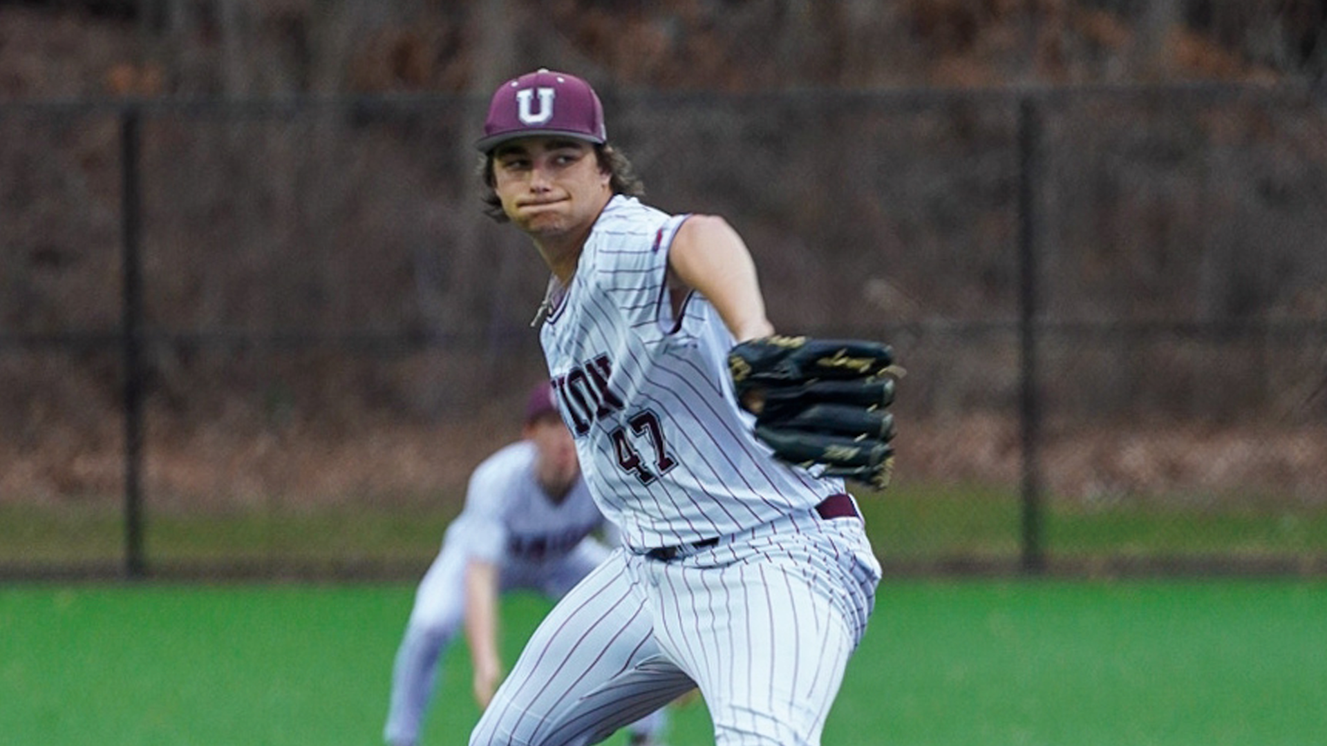 a baseball pitcher throwing a pitch