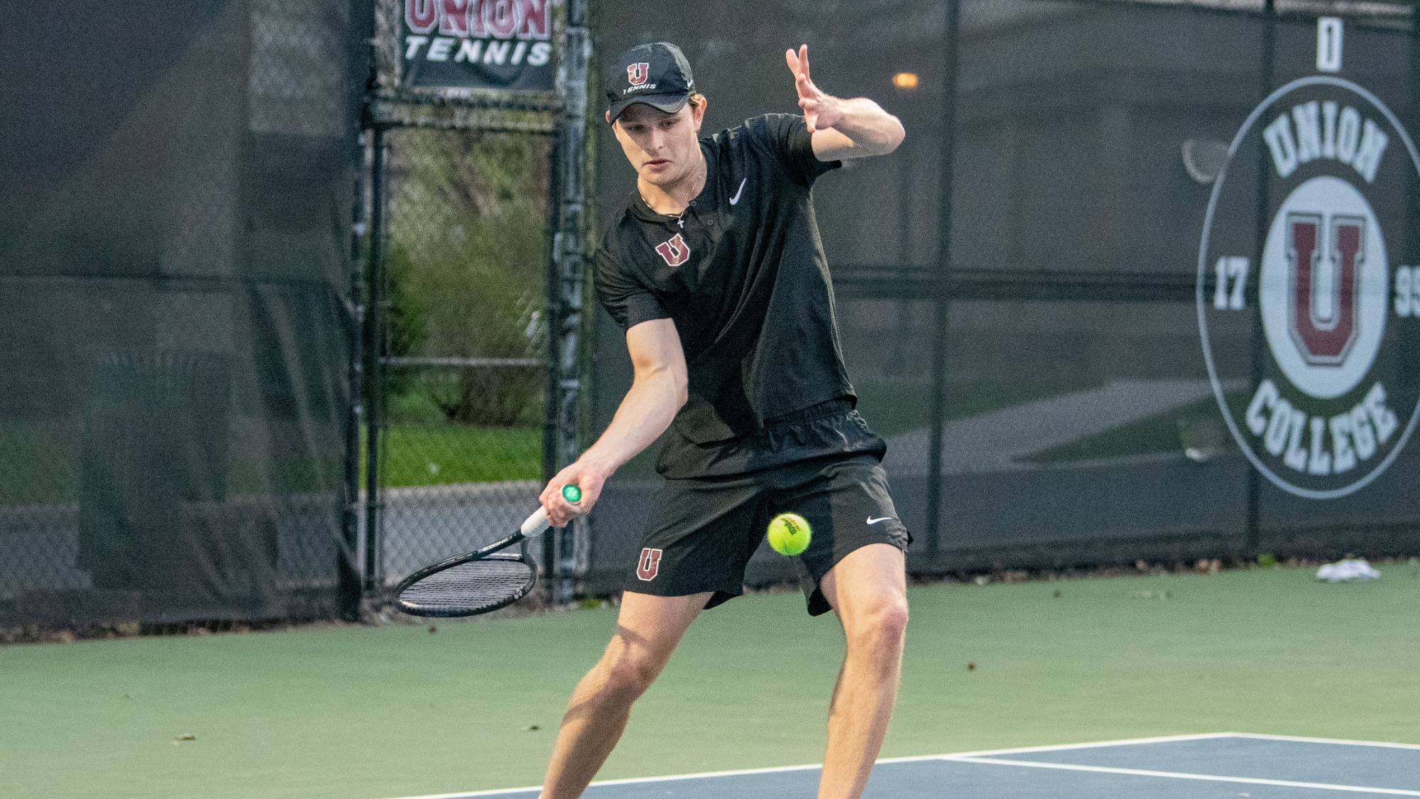 A Union tennis player about to hit a forehand in a tennis match.