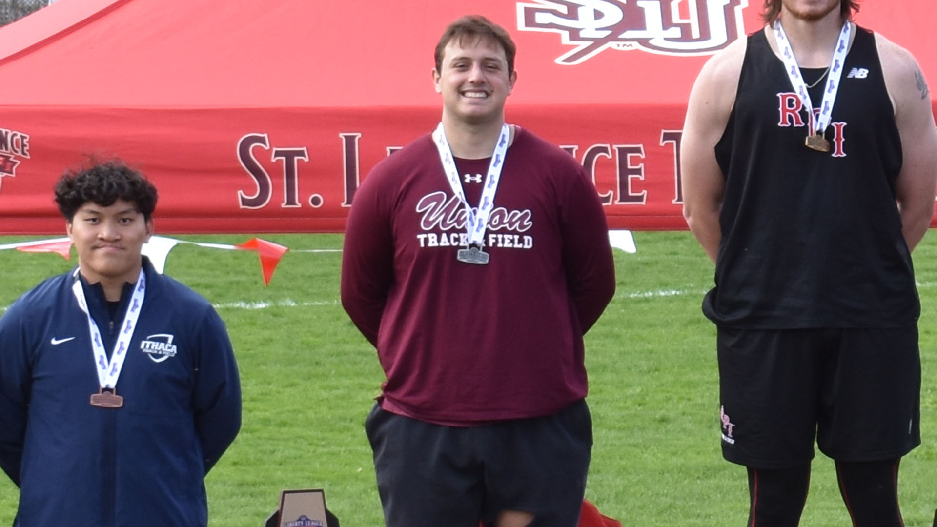 A Union thrower smiling on the podium after the javelin throw.
