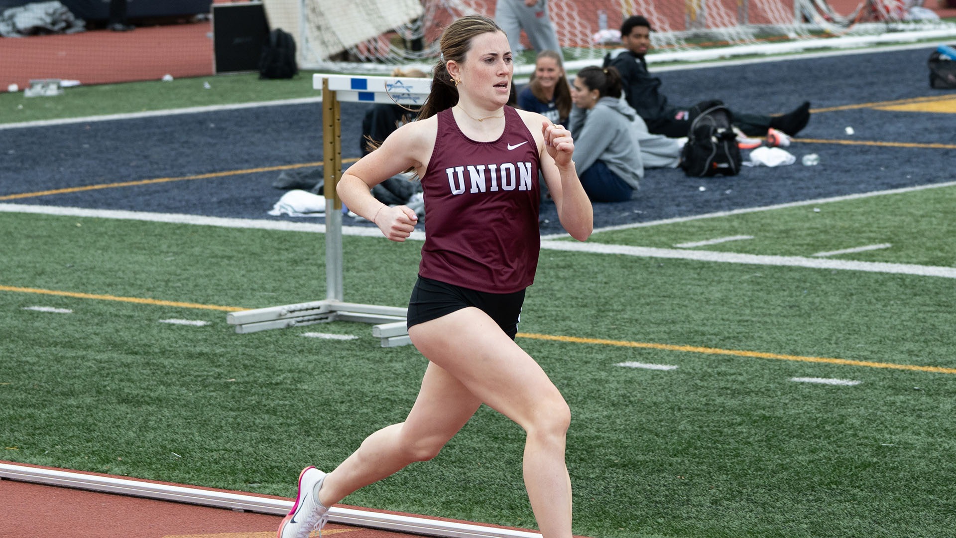 A runner racing down the track in a sprint event.
