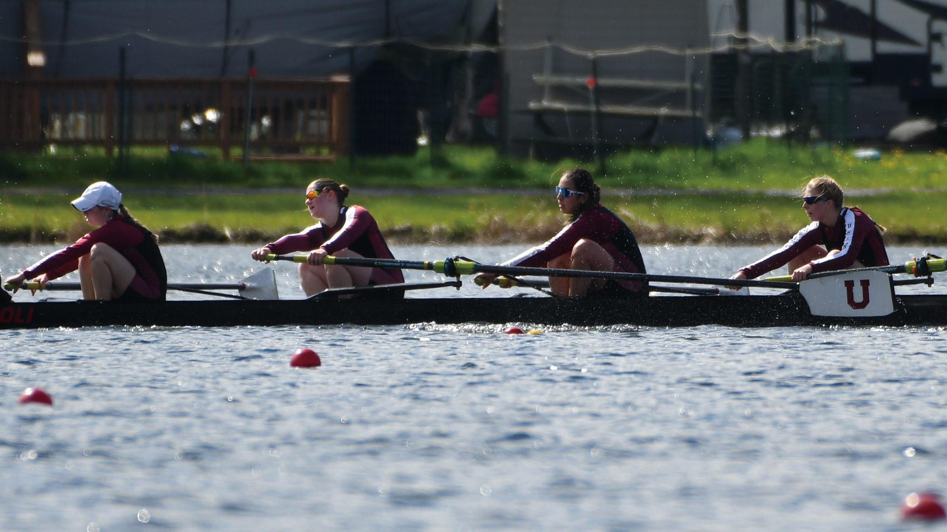 women's crew athletes in a boat, rowing