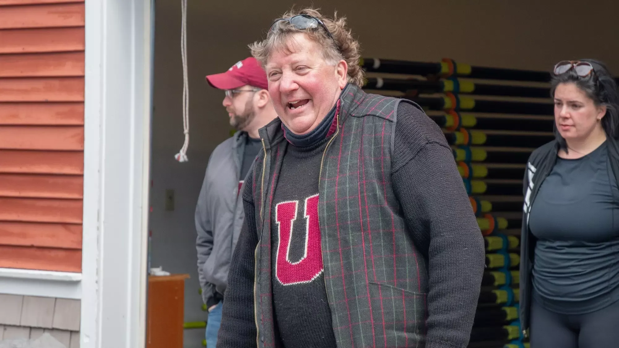 A man laughing with a large Block U on his sweater.