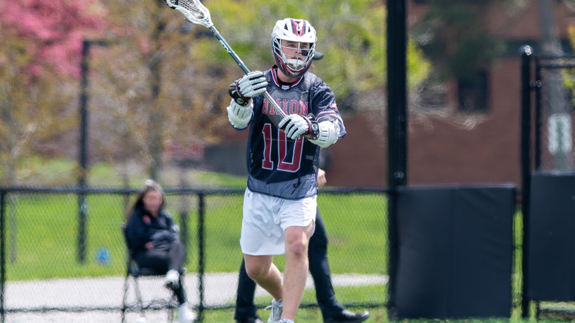 A Union lacrosse player in a gray mesh jersey throws a pass.