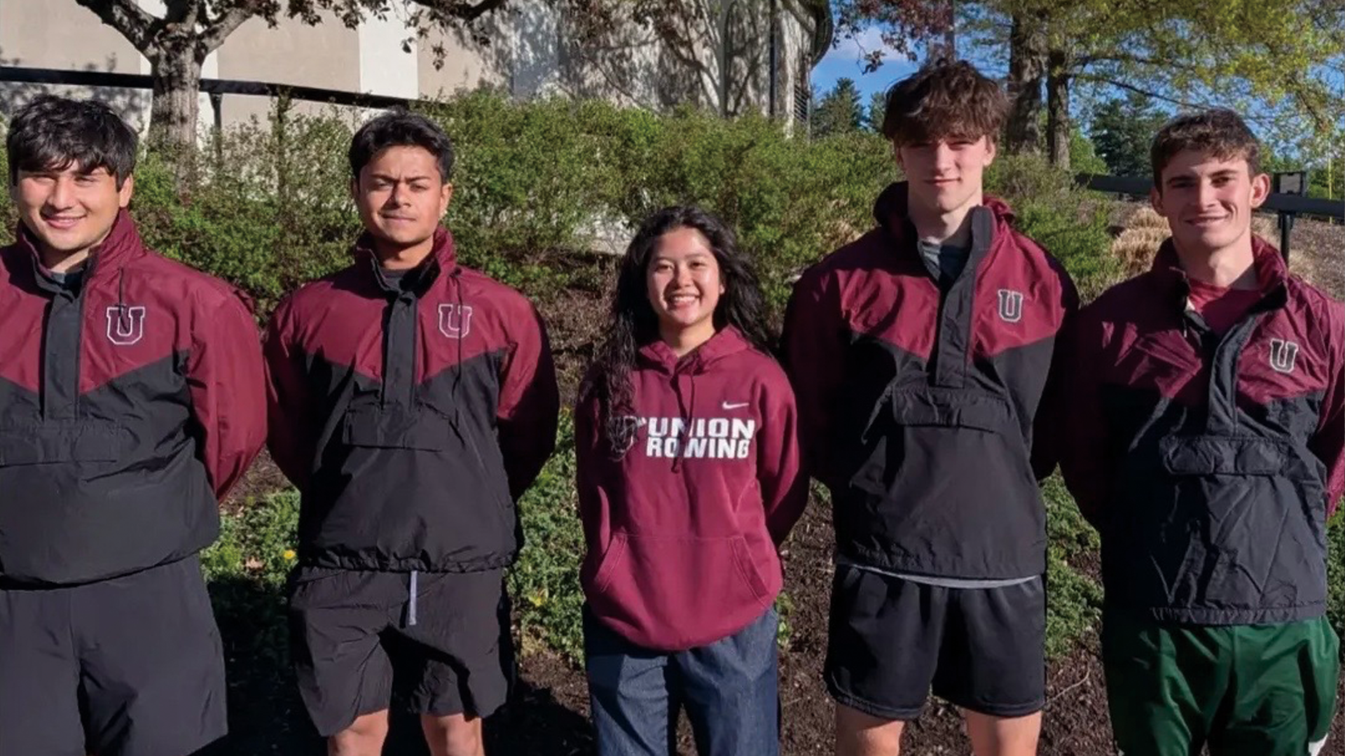 five members of a men's crew team posed for a group photo ahead of a race