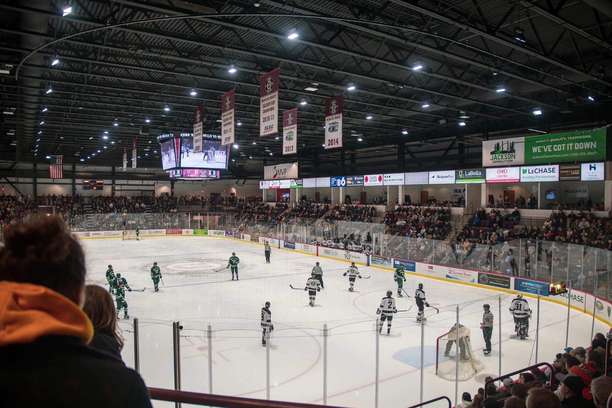 an ice rink photographed from the corner, with the stands full of fans