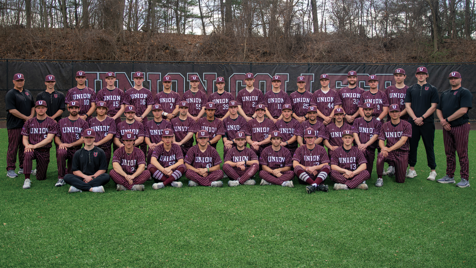a team photo of a baseball team, with the team wearing a garnet-colored uniform with white pinstripes