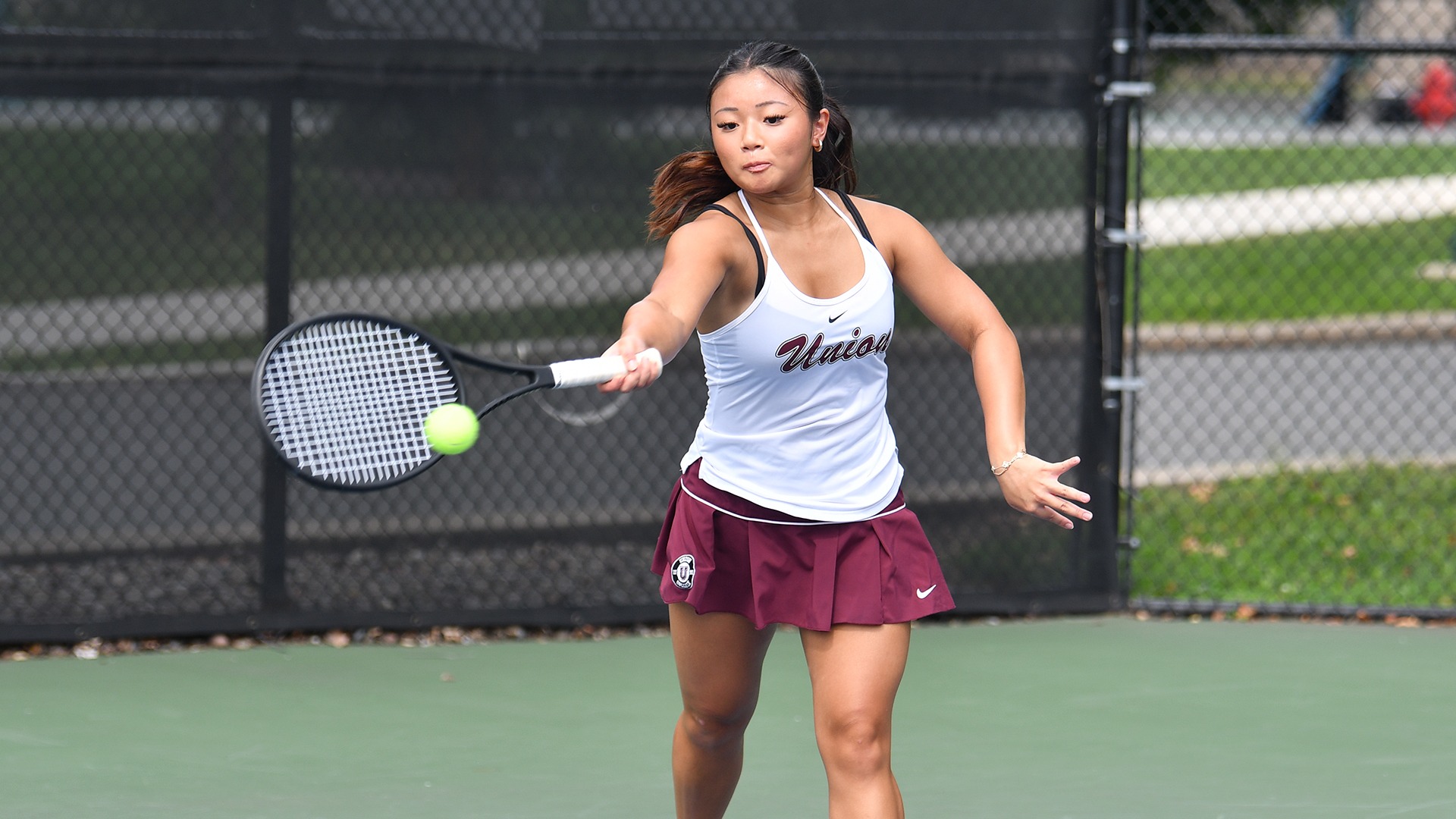A Union tennis player hits a forehand