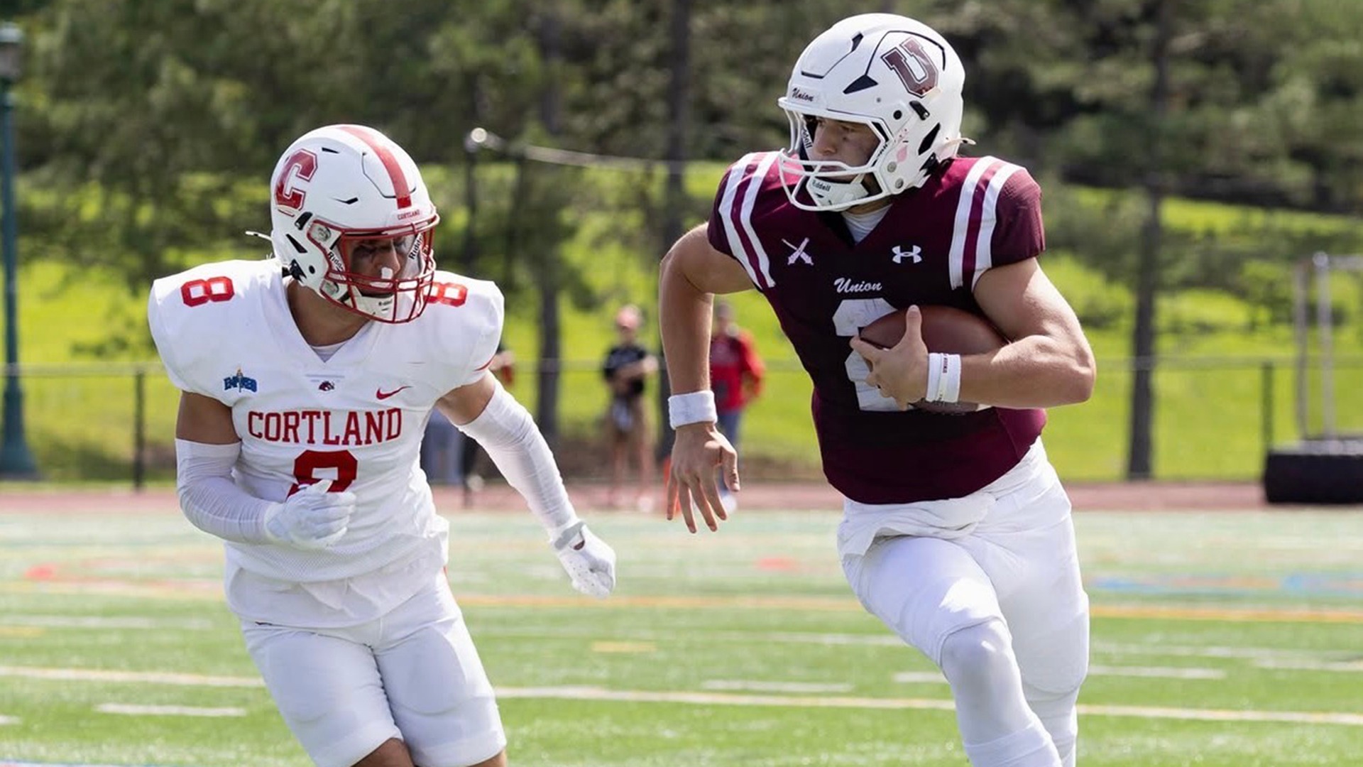 A quarterback runs from a tackle attempt.