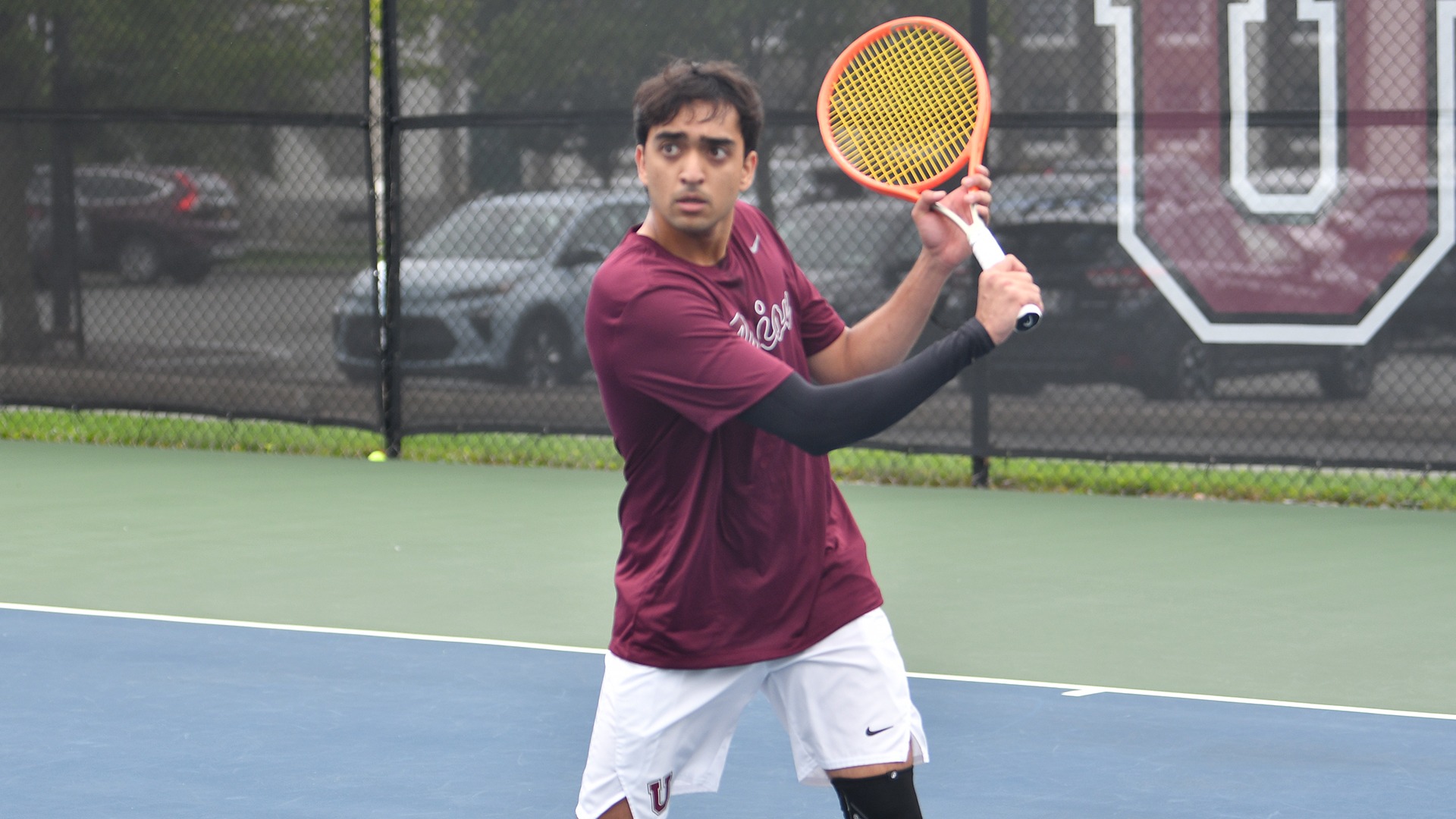 A tennis player at the net awaiting a volley.