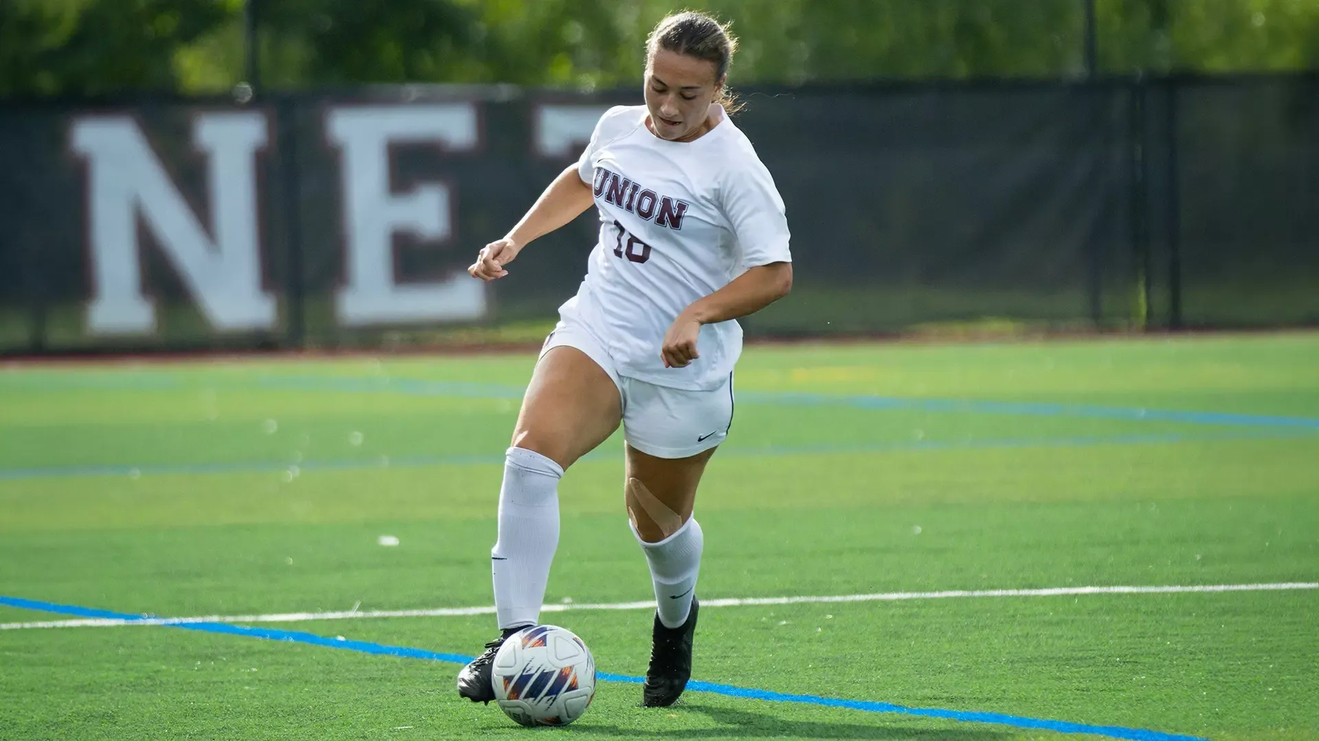 A soccer player dribbling a ball.