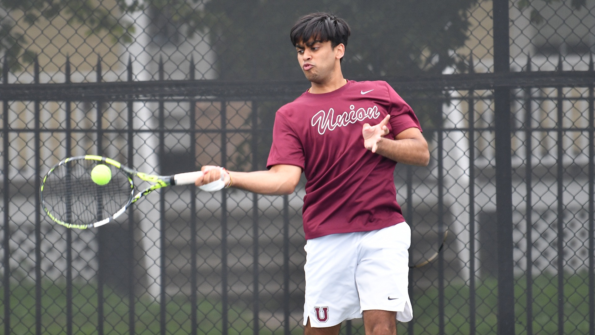 A Union tennis player hits a forehand shot.