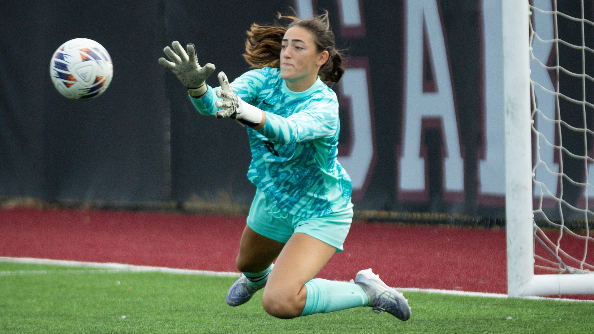 A Union goalkeeper stretches out to stop an oncoming shot.