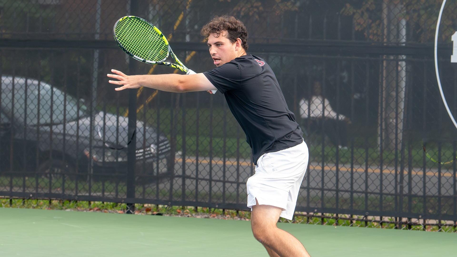 A tennis player gets ready to hit a forehand.