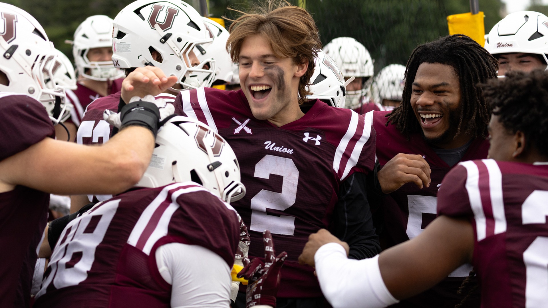 Football players celebrate on the bench after a touchdown 