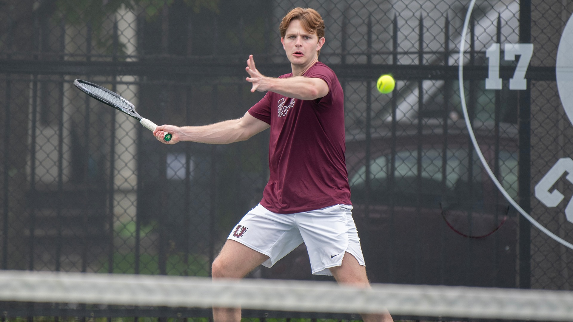 A Union men's tennis player approaches a forehand shot.