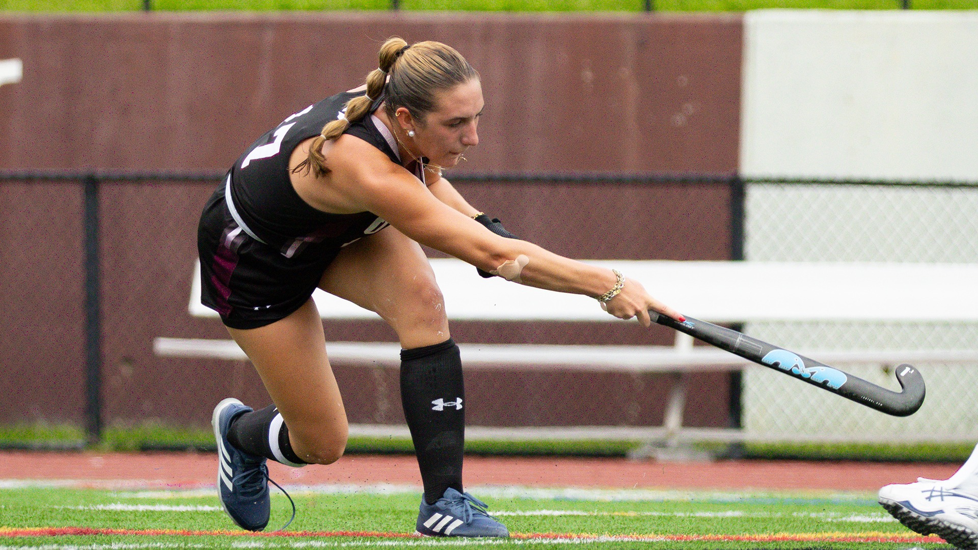 A Union field hockey player follows through after a pass.