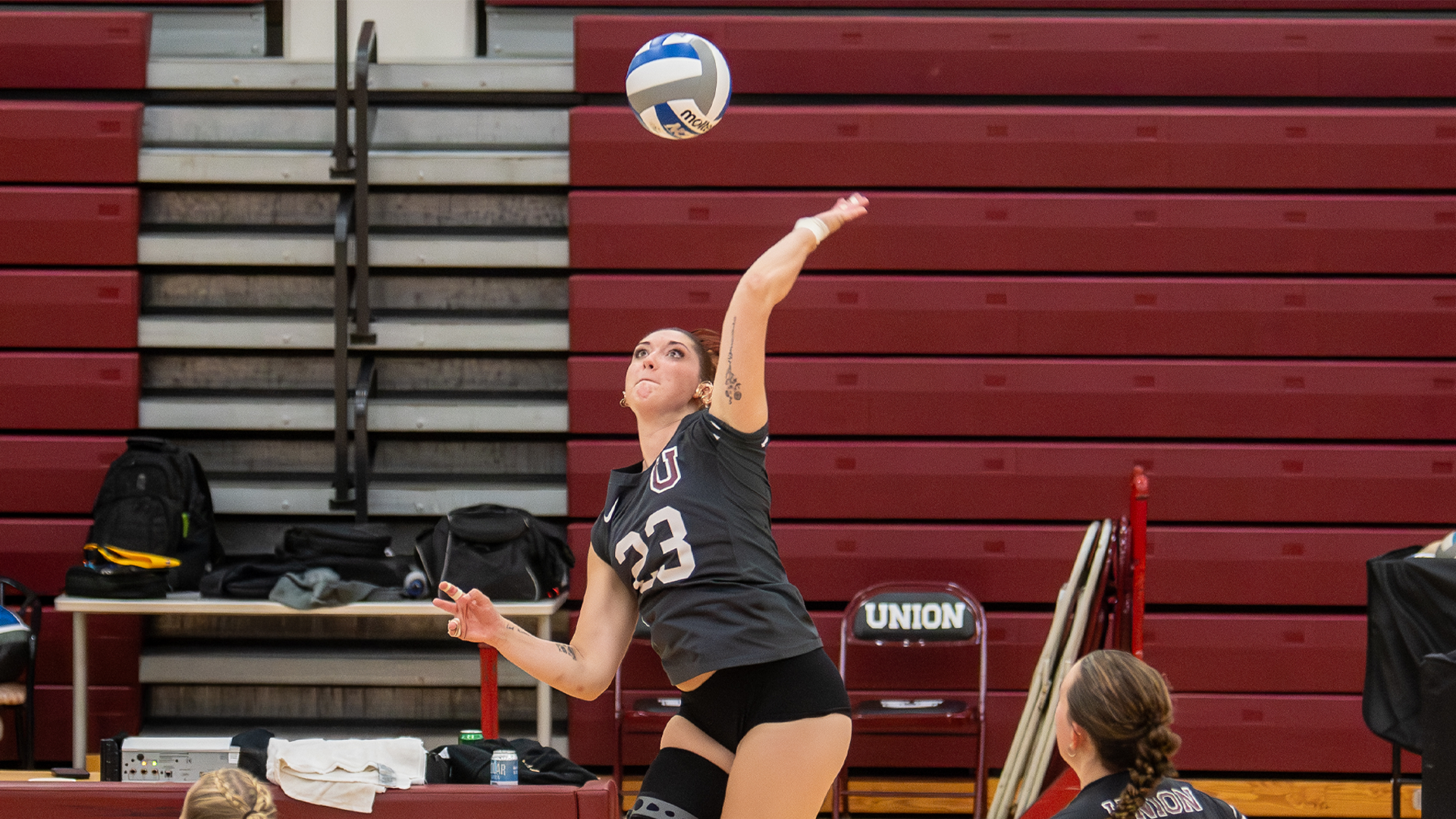 women's volleyball player swinging at a ball
