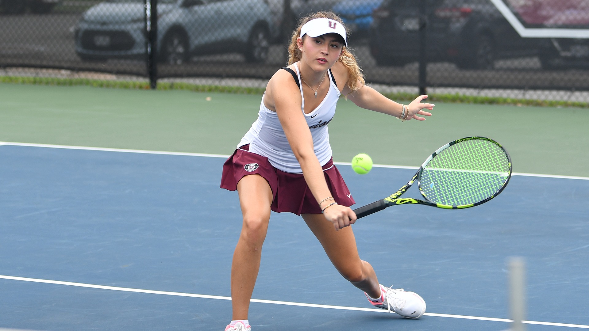 A tennis player hitting a half-volley at the net.