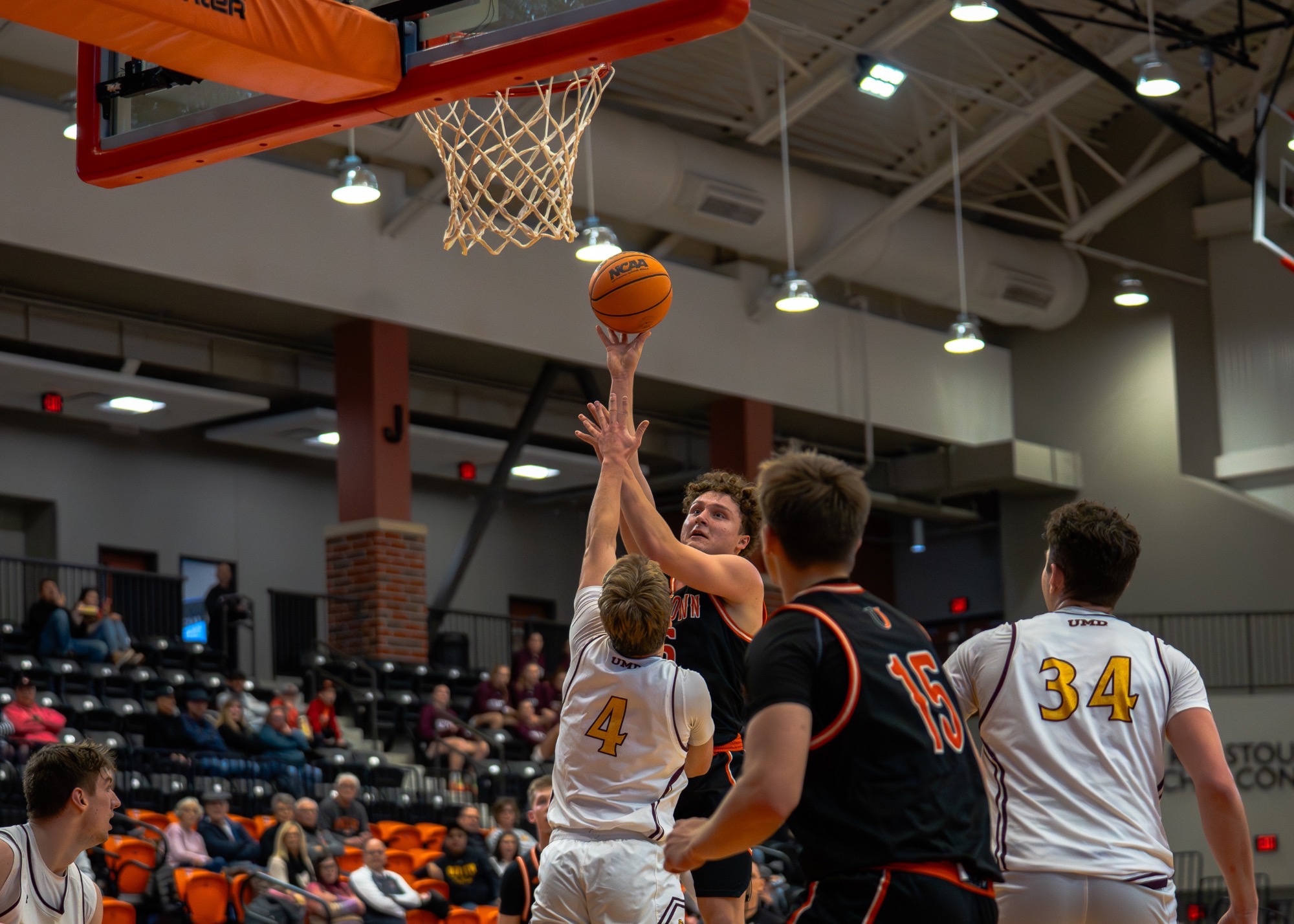 Henry Meyer goes up for a layup against Minnesota Duluth player at the Harold Newman Arena on December 13, 2025