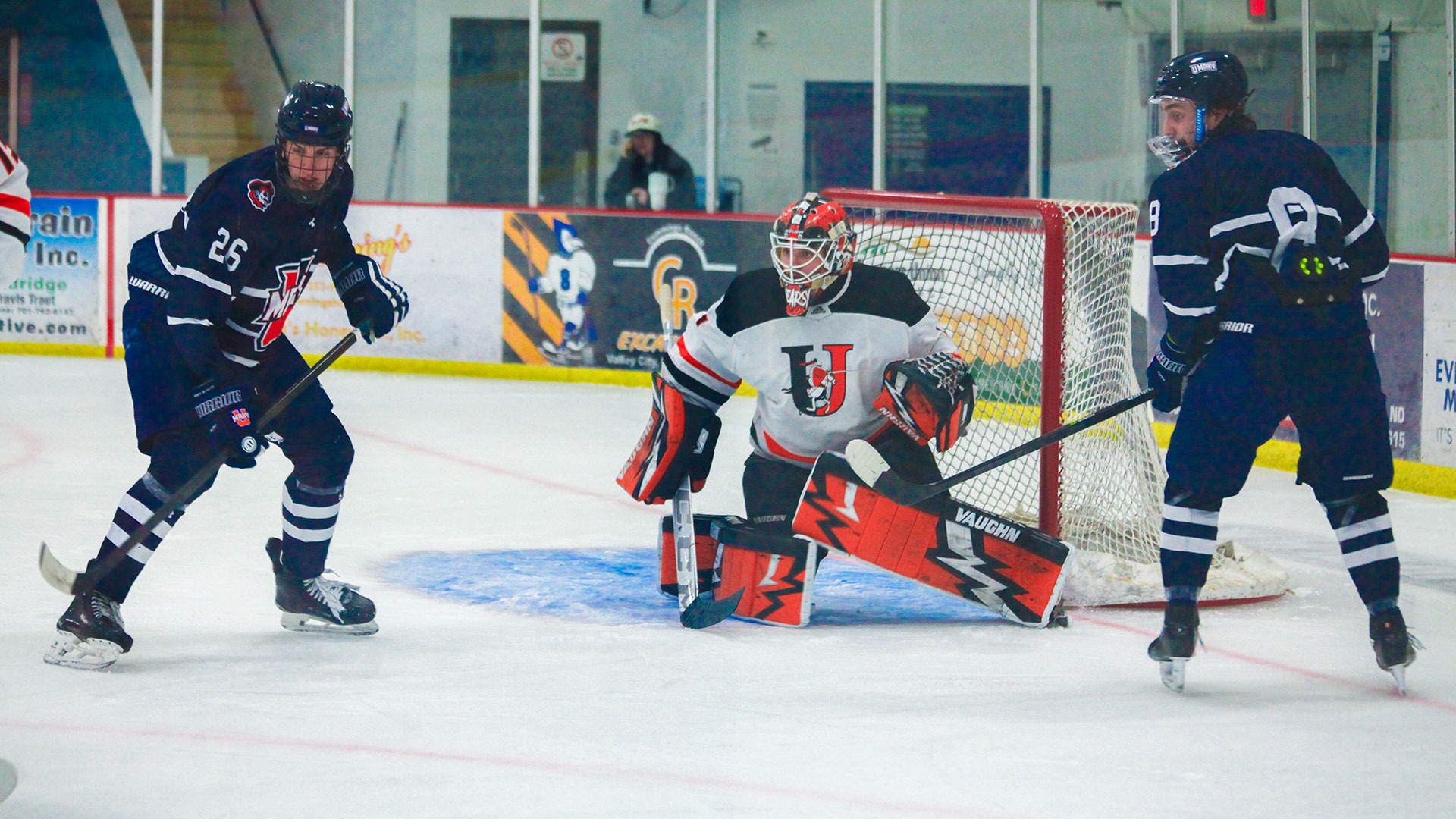 Jimmie goaltender Brandon Weare protects the net from UMary's Isaac Flatley (26) and Joe Gronholz during Wednesday's game at Wilson Arena