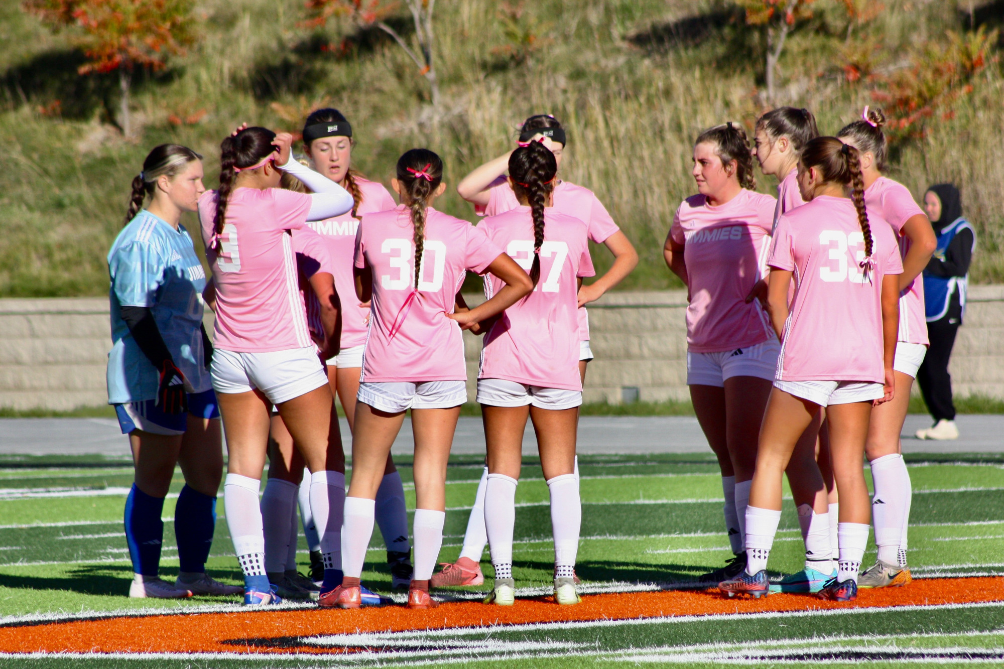 Women's soccer huddles up during a replay review againt Wayne State (10/16)