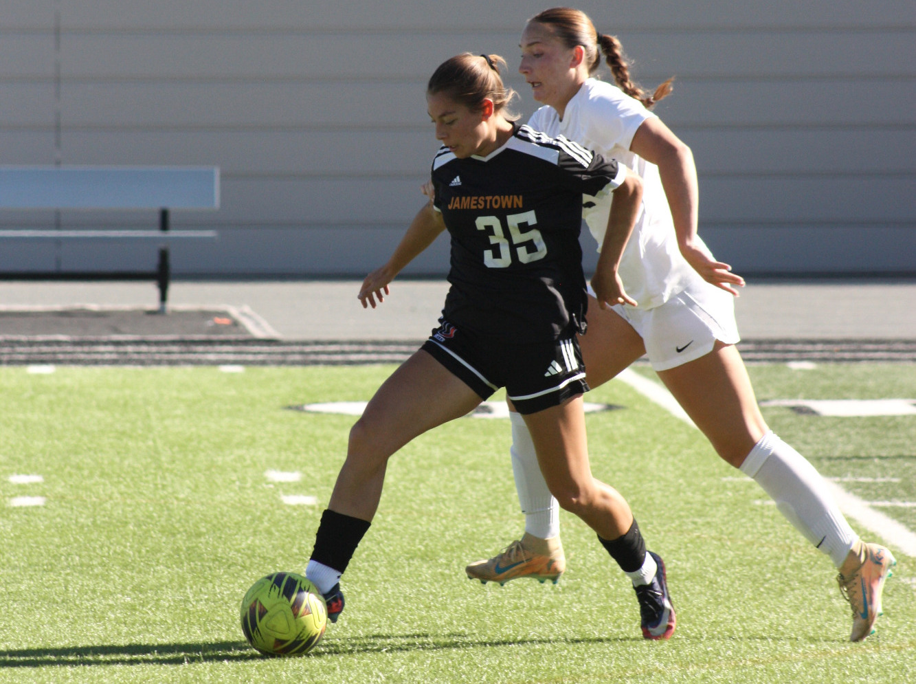 Gaby Lopez dribbles past a defender against Augustana (10/18)