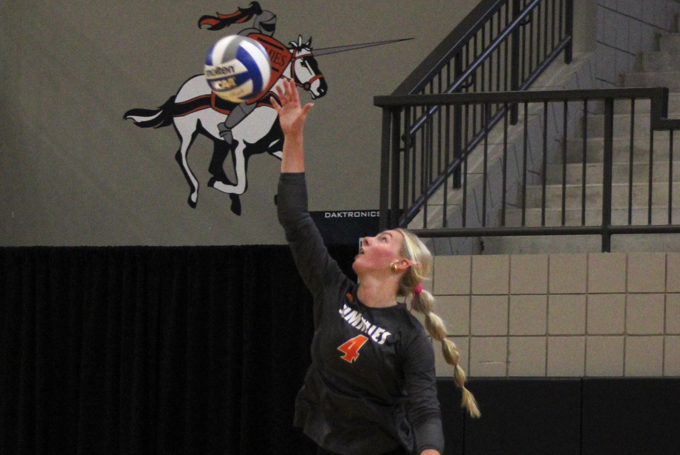Mya Foslien lines up a service against Minnesota Crookston 