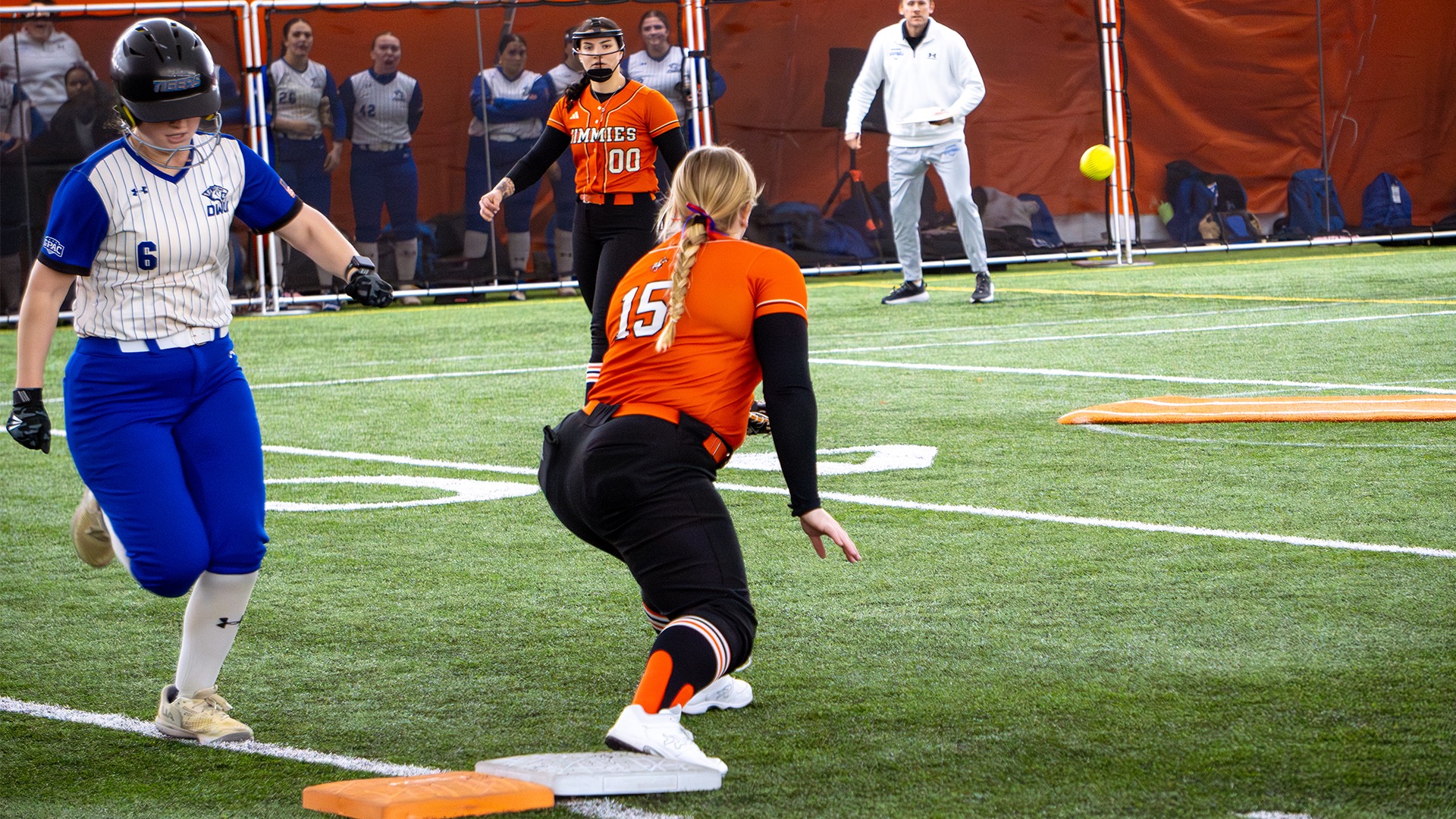 #15 Sydney Grendler stretches out to make the out at first of runner #6 DWU Jordyn Blogg 