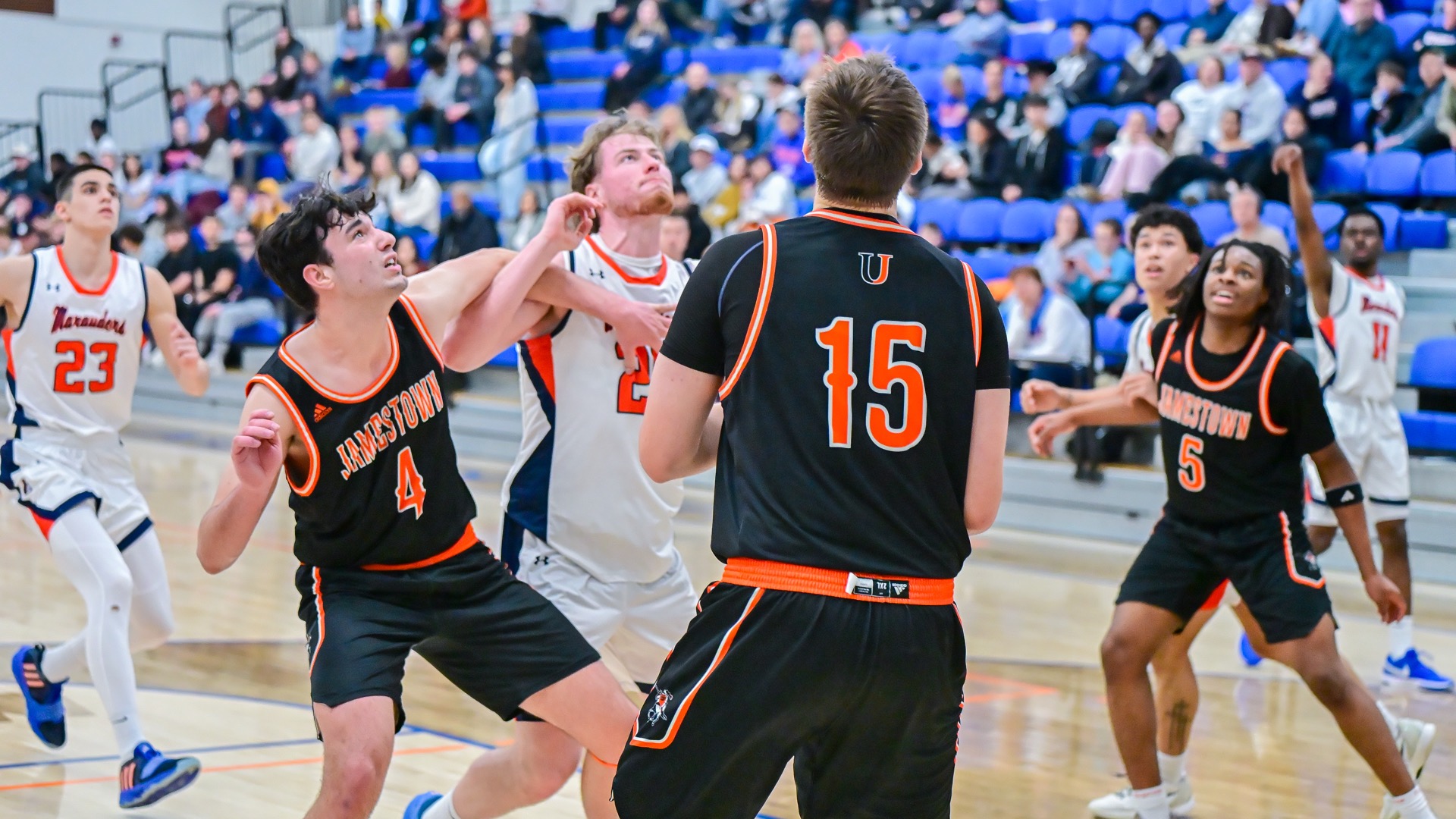 UJ Aiden Johnson, Carson Woodford and Ford Okehi look on for the rebound 