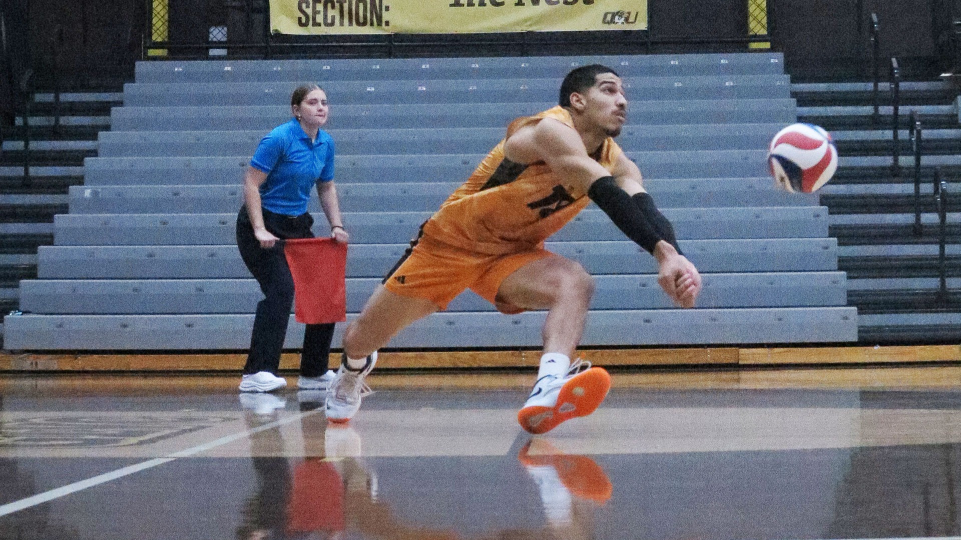 Ladarius Williams goes for a dig against Quincy University earlier this season