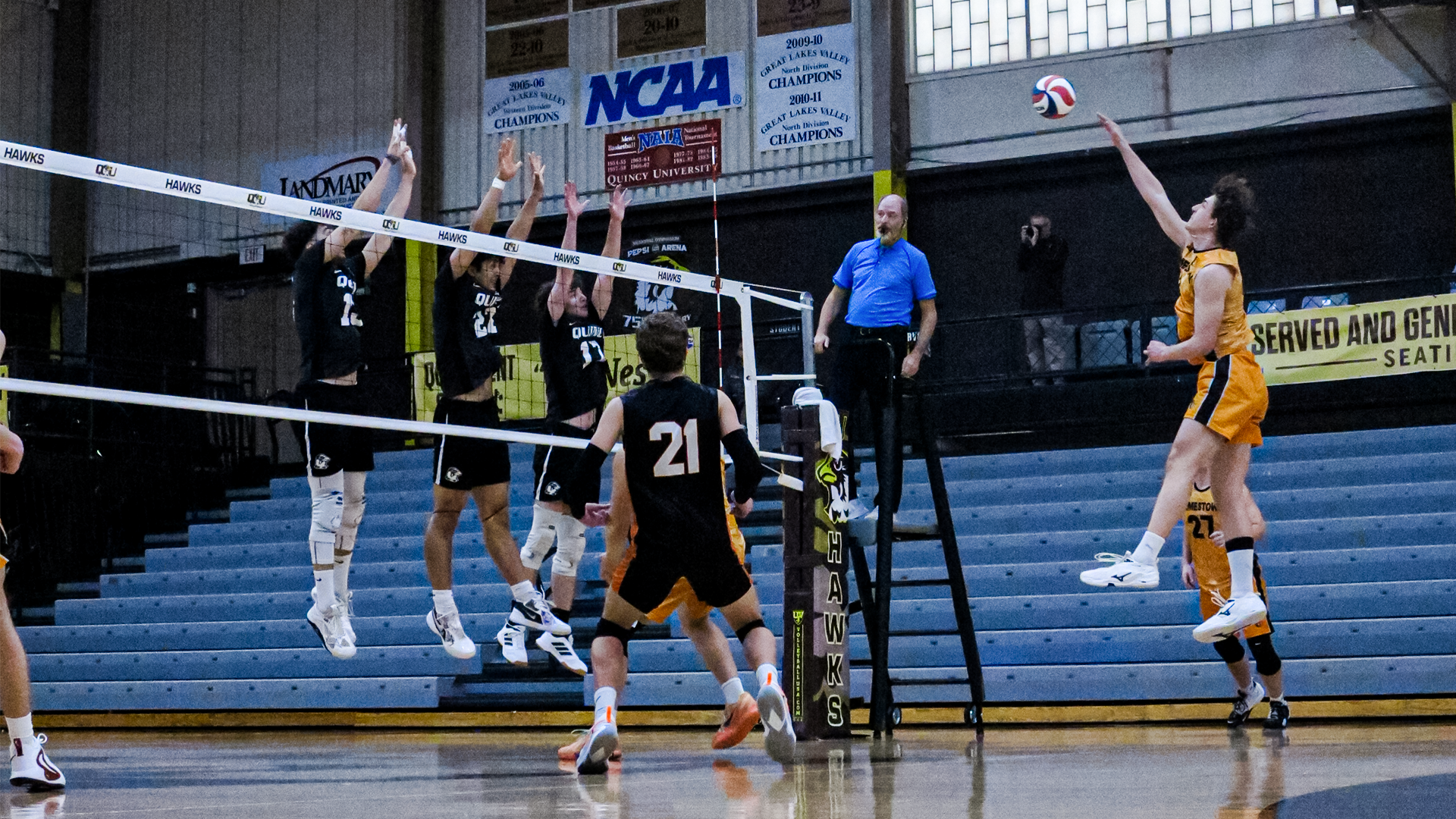 Jamestown libro jumping from the back row to attack a ball