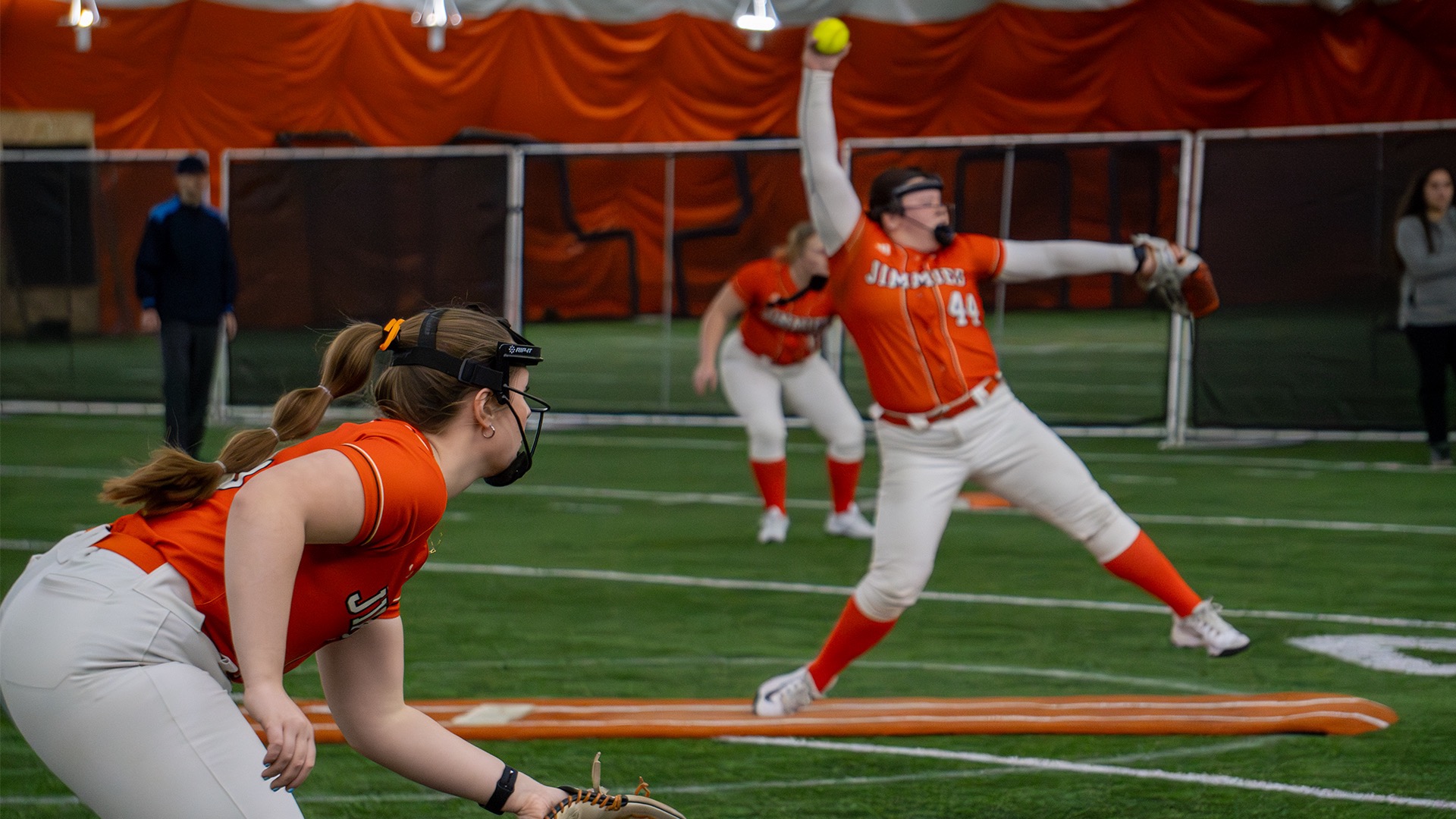 UJ #44 Hope Ransome winds up to pitch while 55 Amanda Burch and #15 Sydney Grendler get in defensive postion in the Nelson Family Bubble 