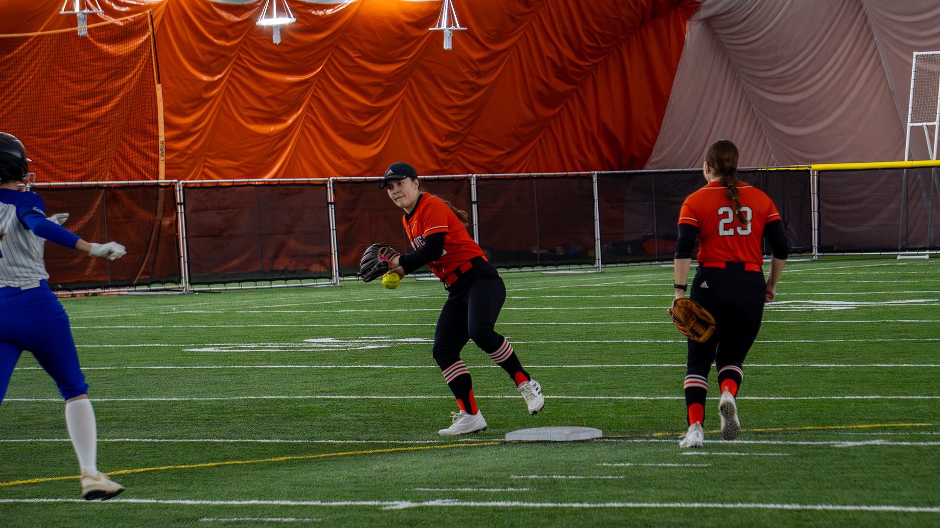 Jamestown #10 Maddie Speath tags second base for the forced out and draws back to throw to first for the out 