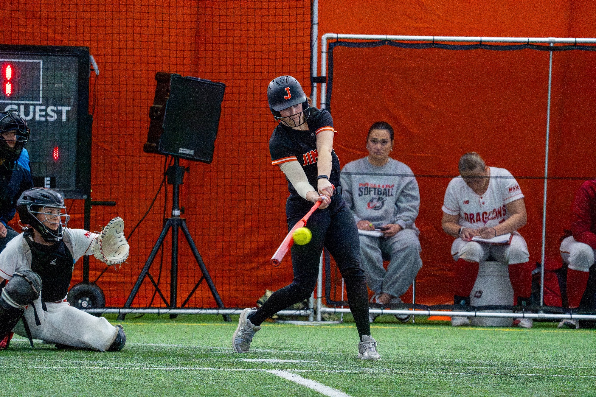 Jamestown #13 Katie Falk makes contact with the ball in UJ’s first game doubleheader against MSUM April 3 in the Nelson Family Bubble 