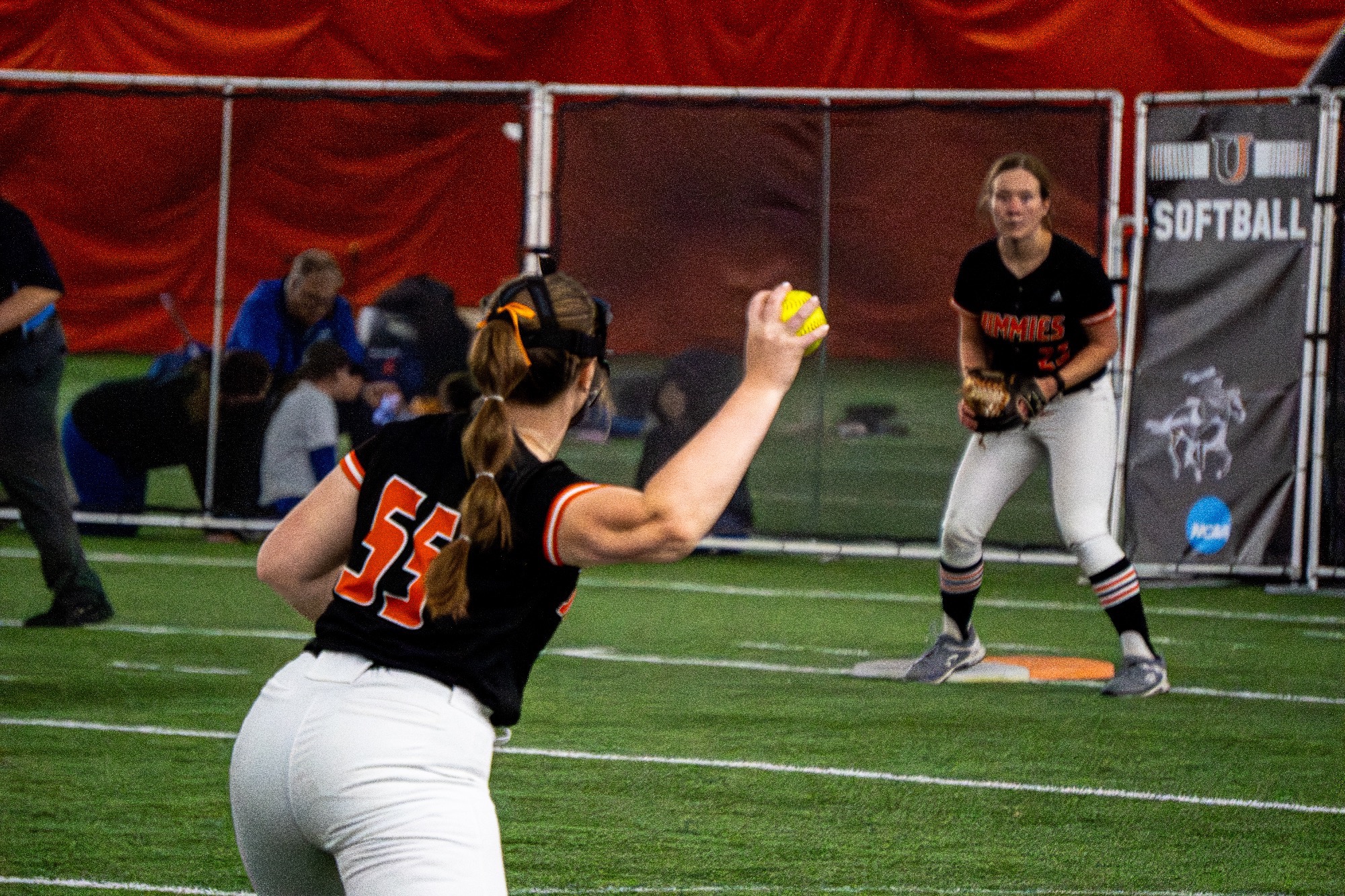 #55 Amanda Burch reels back to throw the ball to get an out to UJ 1st baseman #25 Kylie Yansuk in the Nelson Family Bubble March 29, 2026