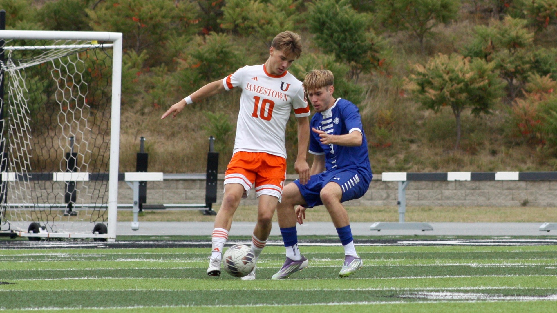 UJ's Nuutti Norhomaa fights for possession against DWU's Noah Gusterer in Saturday's match.