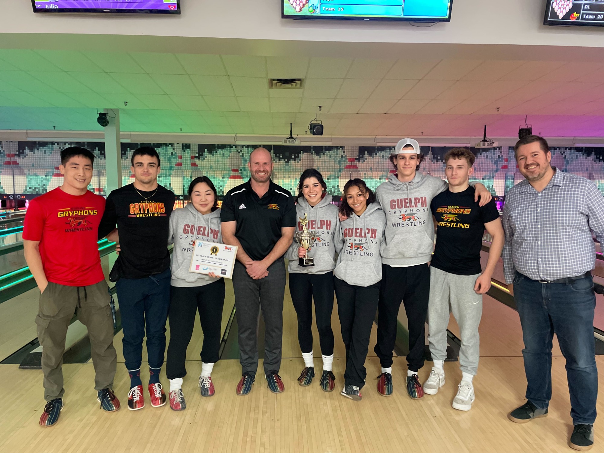 Participants pose for photo at bowling alley in support of Big Brothers Big Sisters