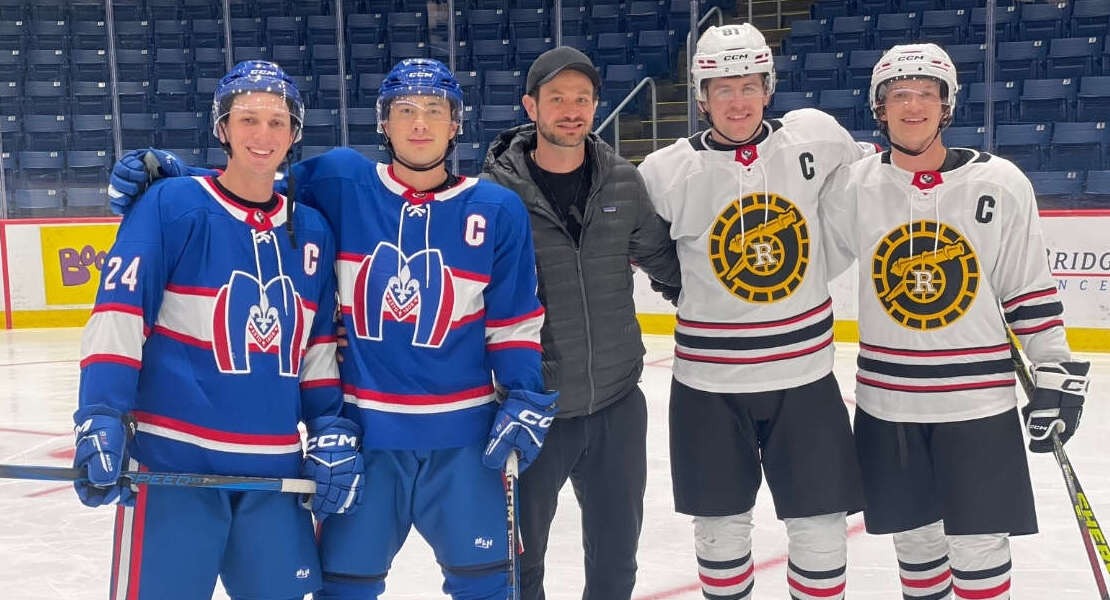 Gryphon men's hockey player Johan De Simone on set as extras for Heated Rivalry pose with stars Connor Storrie and Hudson Williams