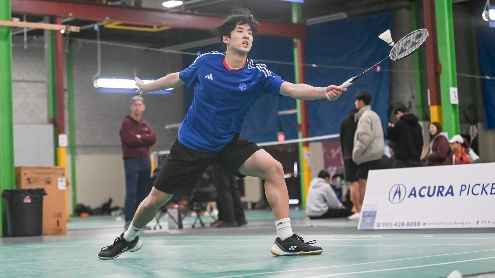 Joshua Nguyen striking a shuttlecock