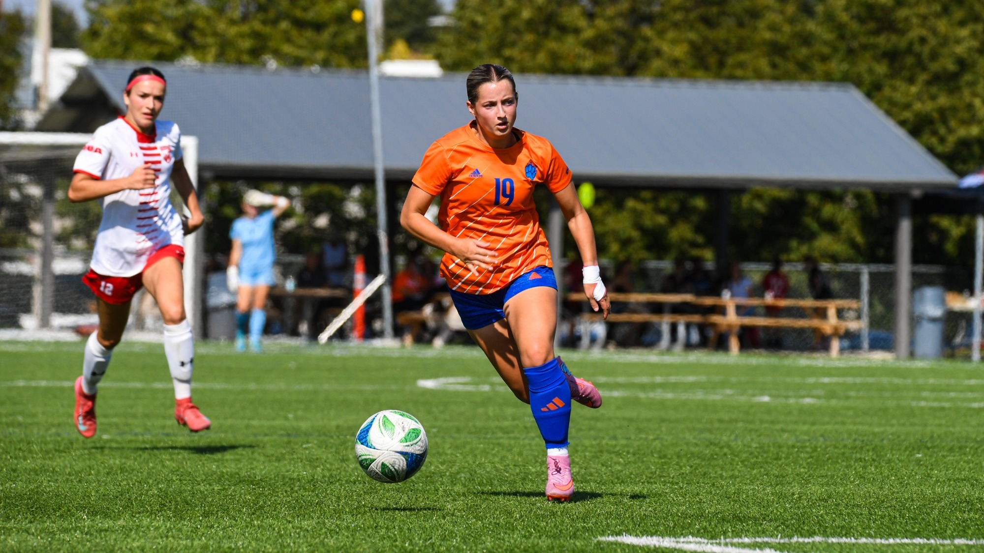 Mackenzie Scott running with soccer ball